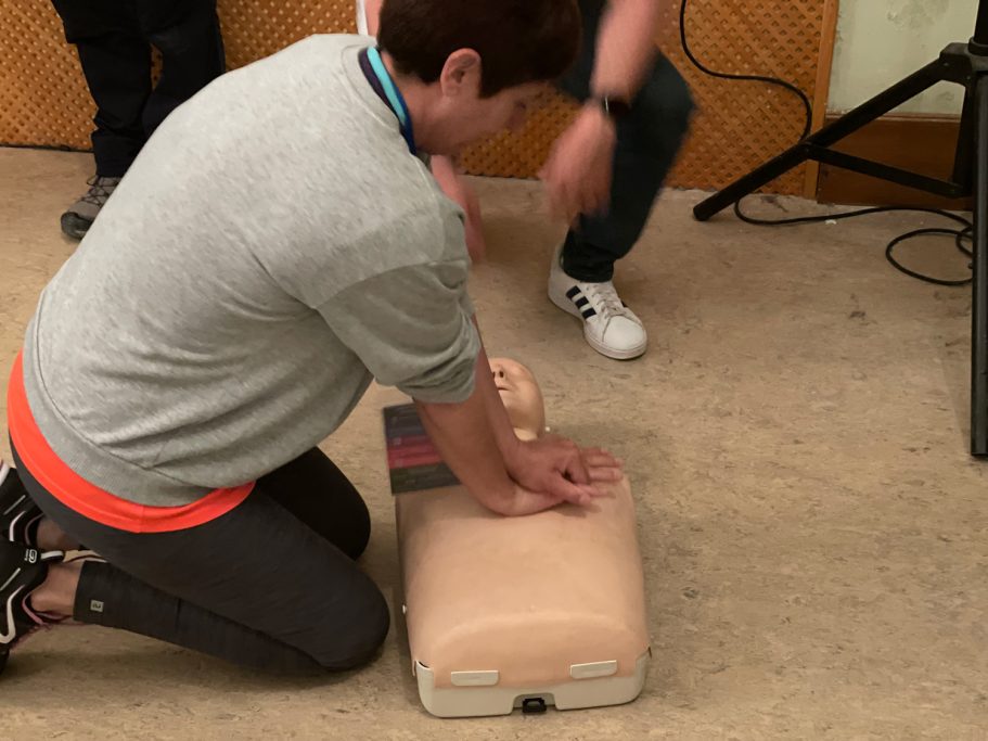 Mujer realizando maniobras de RCP en un maniquí de entrenamiento.